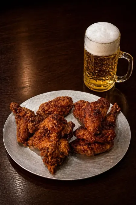Korean fried chicken on a plate with a beer mug